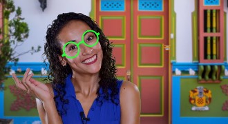 A Colombian actress with round glasses like the ones Mirabel wears in Encanto