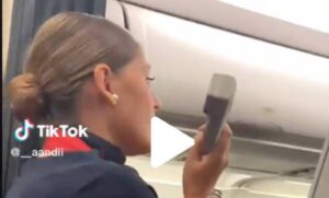 A screenshot of a TikTok video showing a flight attendant