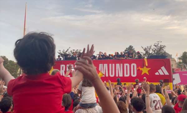 Spanish supporters watch the 2026 World Cup champions celebrate on a parade bus in the streets of Madrid.